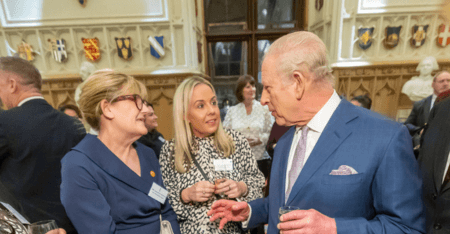 Amandajayne speaking to the King in a stately room at Windsor Castle, for the Royal Reception for social care.