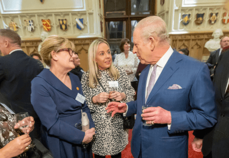 Amandajayne speaking to the King in a stately room at Windsor Castle, for the Royal Reception for social care.