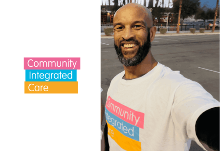 A Community Integrated Care logo next to a selfie of Jamie Jones‑Buchanan. He is outside, smiling to camera and wearing a Community Integrated Care t-shirt.