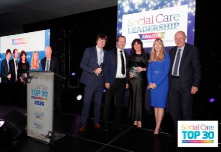 Sara murphy on stage collecting her award at the Social Care Leadership Awards.